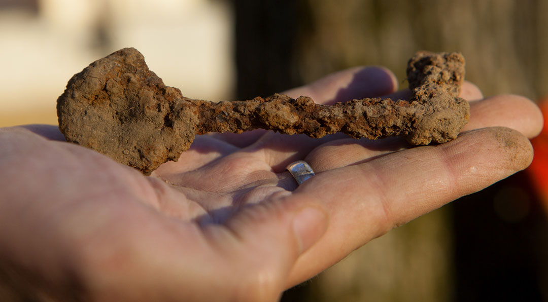 History, bit by bit: Among smaller artifacts — coins, bits of glass, pipe stems, a jack — students unearthed a heavy, rusted skeleton key. Archaeology of College Hill