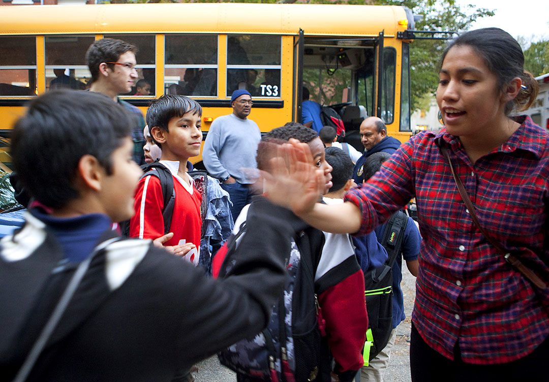 Fun by the bagful: Anahi Garcia ’14 high-five’s departing D’Abate School students, who boarded buses and rode off with bags of loot. Fun by the bagful: Anahi Garcia ’14 high-five’s departing D’Abate School students, who boarded buses and rode off with bags of loot.